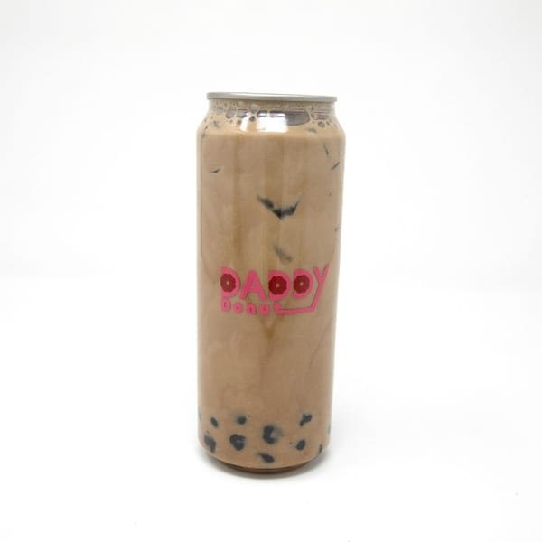 Daddy Donut's iced coffee with boba pearls in a clear can against a white background.