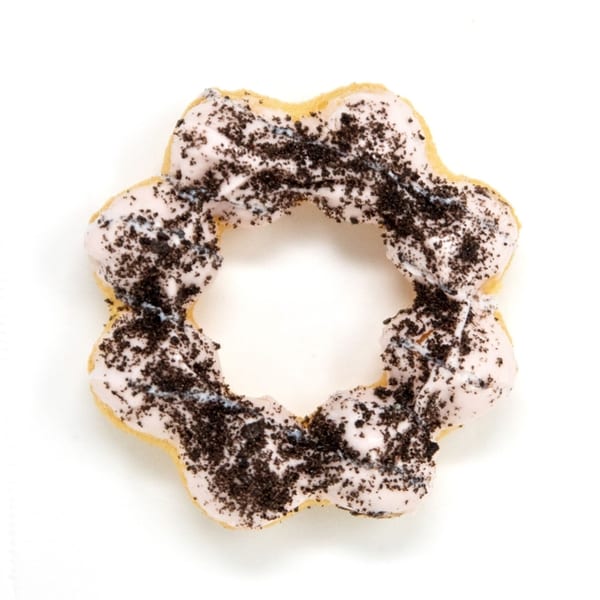 A star-shaped Daddy Donut with white icing and dark cookie crumbles on a white background.