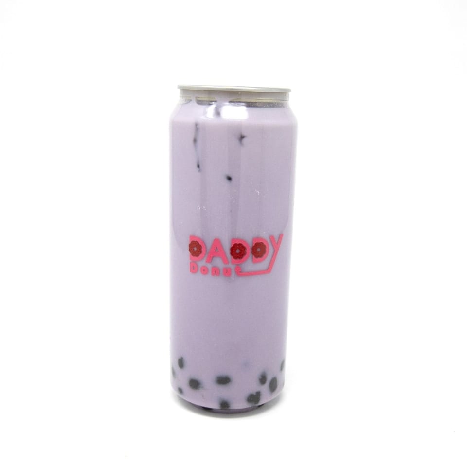 A Daddy Donut canned taro bubble tea with black boba pearls against a white background.