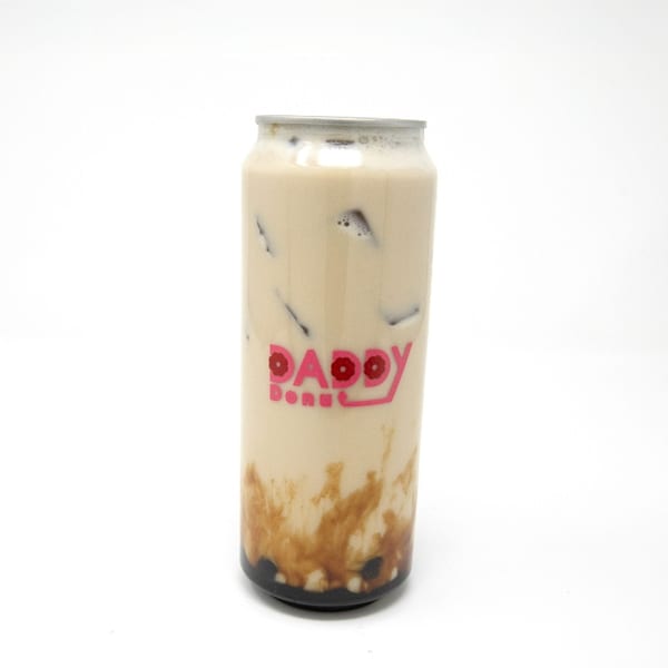A Daddy Donut branded can of iced coffee with brown sugar swirls and boba pearls.